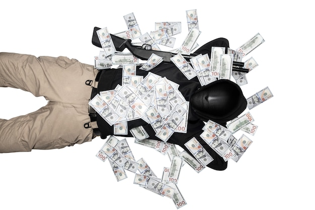 Criminal man in a hidden mask lying down with a shotgun and lots of money isolated over white background