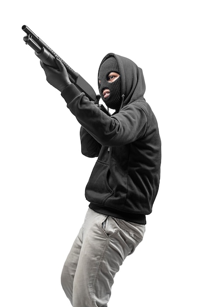 Criminal man in hidden mask pointing the shotgun isolated over white background