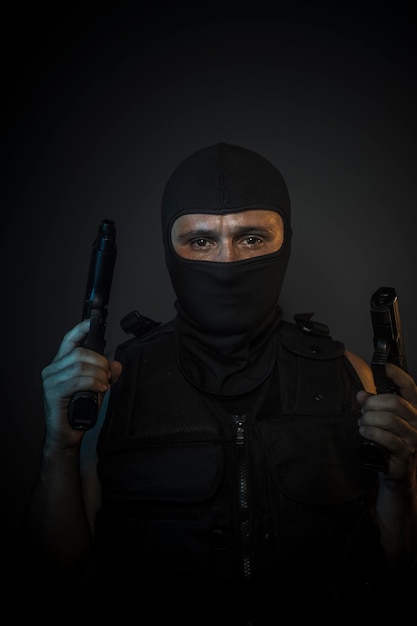 Criminal, Man wearing balaclavas and bulletproof vest with firearms