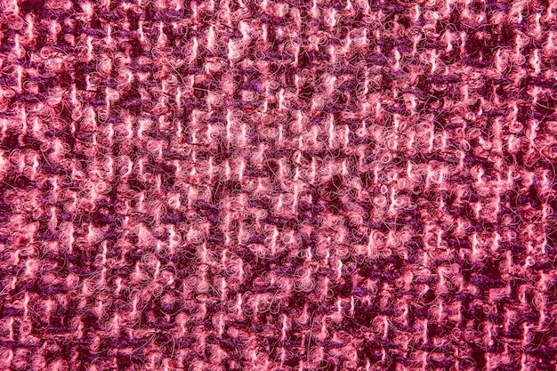 Crimson tweed like texture, varicolored wool pattern, textured  melange upholstery fabric background copy space.  Background texture of twill