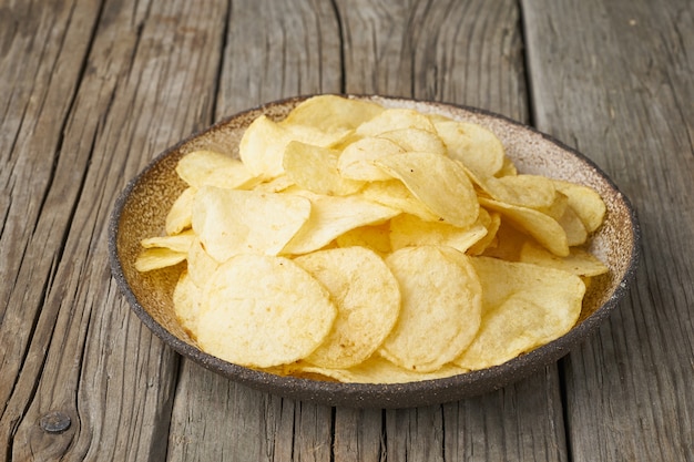 Crisp in bowl, wooden , closeup