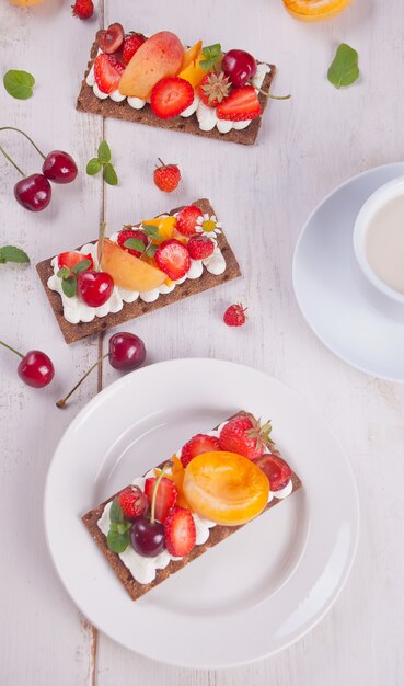 Crisp bread with creme cheese, fruit and berries