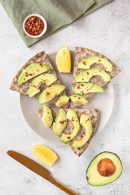 Crisp rye bread sandwiches with avocado slices