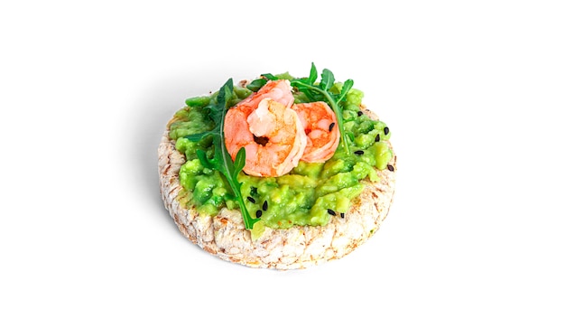 Crispbread sandwich with guacamole, shrimps, arugula, cucumber isolated. Bruschetta with avocado. Healthy breakfast