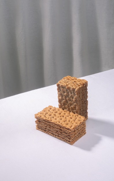 Crispbread on a white table, isometric creative minimalism concept