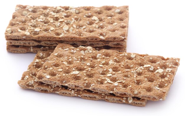 Crispbread with sesame seeds over white background