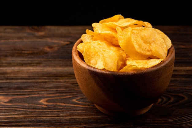 Crisps on dark wood.