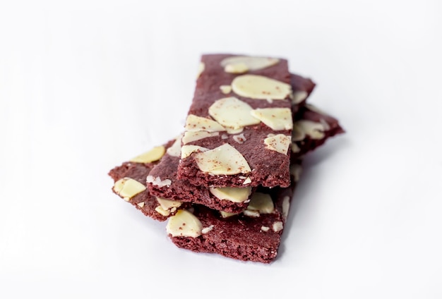 Crispy brownies cracker snack with almond nut on white isolated surface