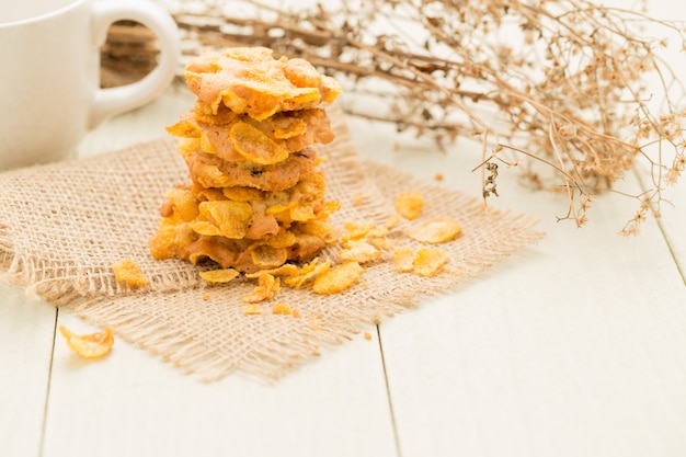 Crispy cereal cookies on white wooden table