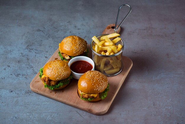 Crispy Chicken Cheese slider with fries served in dish isolated on grey background top view of bahrain food