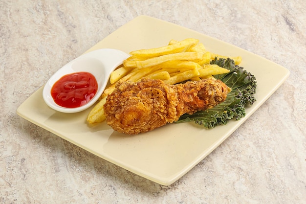 Crispy chicken leg with fry potato and sauce