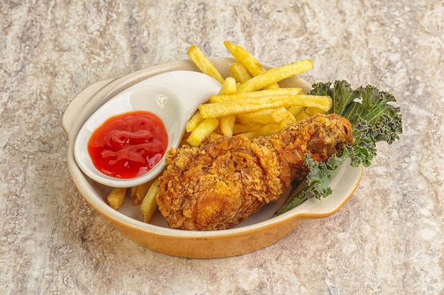 Crispy chicken leg with fry potato and sauce