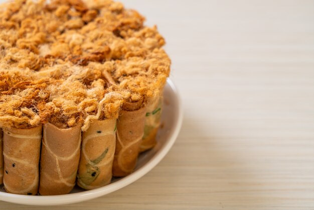 crispy coconut roll with dried shredded pork on plate