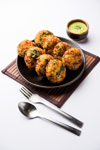 Crispy Corn Tikki, pakora or pakoda or pattice also known as cutlet. served with green chutney. Selective focus