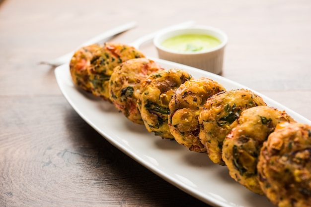 Crispy Corn Tikki, pakora or pakoda or pattice also known as cutlet. served with green chutney. Selective focus