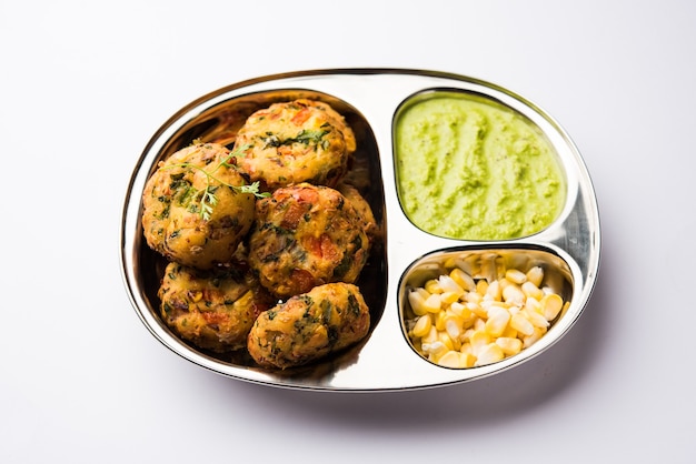 Crispy Corn Tikki, pakora or pakoda or pattice also known as cutlet. served with green chutney. Selective focus