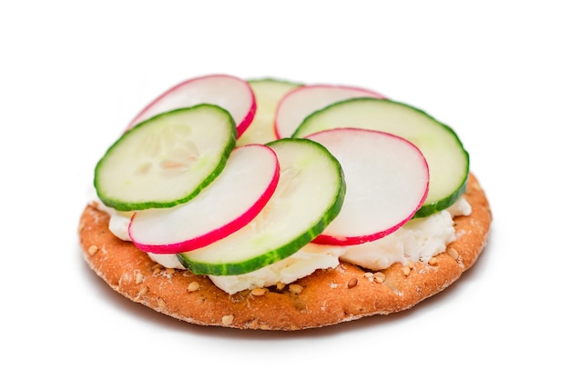 Crispy cracker sandwich with cream cheese fresh cucumber and radish