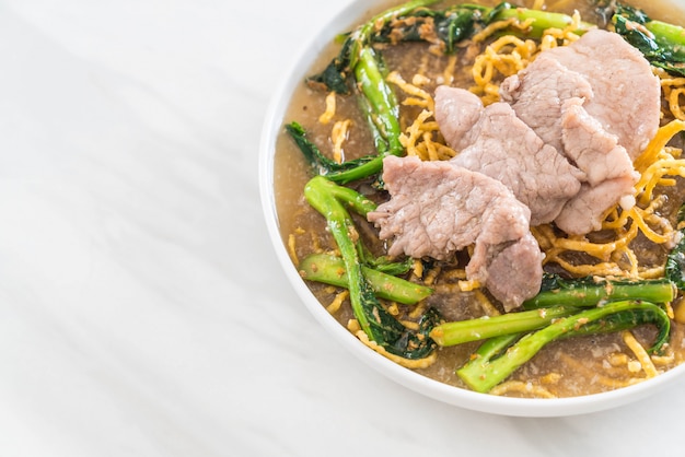 crispy egg noodles with chinese broccoli and pork