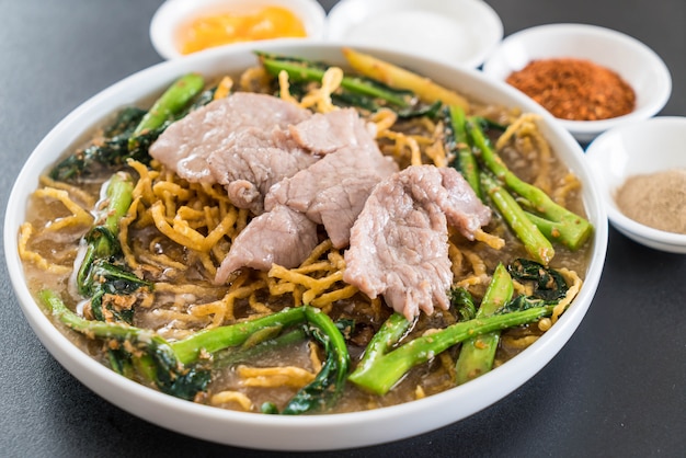 crispy egg noodles with chinese broccoli and pork