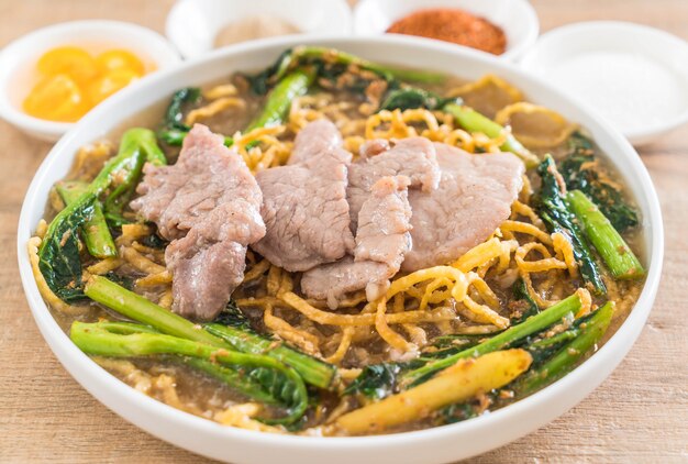 crispy egg noodles with chinese broccoli and pork