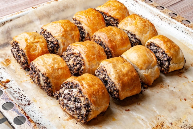 Crispy freshly baked cookies with poppy seeds on a baking tray