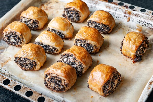 Crispy freshly baked cookies with poppy seeds on a baking tray