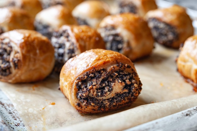 Crispy freshly baked cookies with poppy seeds on a baking tray