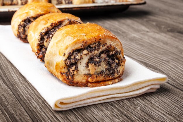 Crispy freshly baked cookies with poppy seeds on a wooden background