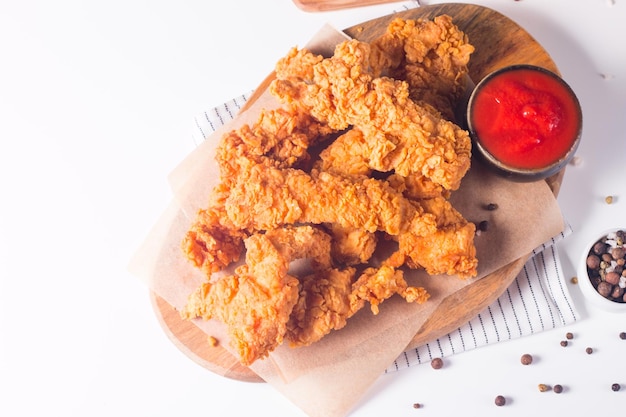 Crispy fried chicken breast strips with sauce