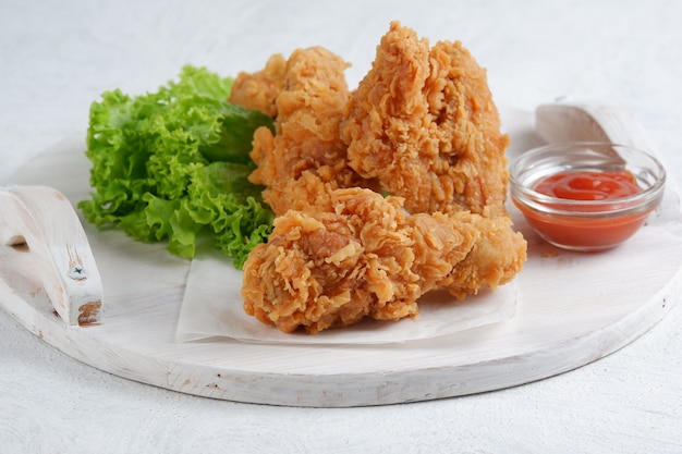 crispy fried chicken with chilli sauce on white background