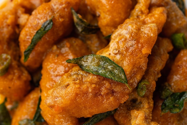 Crispy fried dori fish coated with salted egg plated on a white plate