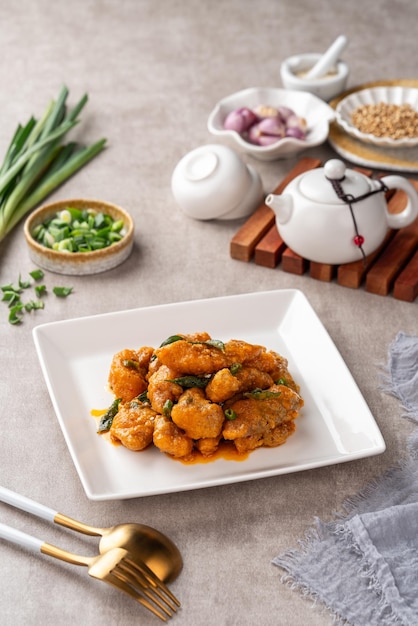 Crispy fried dori fish coated with salted egg plated on a white plate