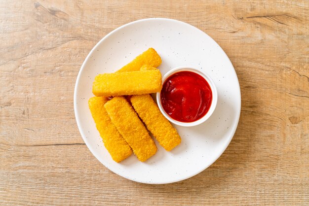 crispy fried fish fingers with breadcrumbs served on plate