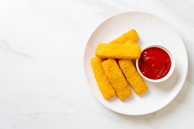 crispy fried fish fingers with breadcrumbs served on plate