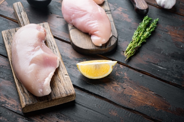 Crispy garlicky chicken raw ingredient, on dark wooden table