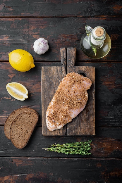 Crispy garlicky chicken raw ingredient,  on wooden table, flat lay