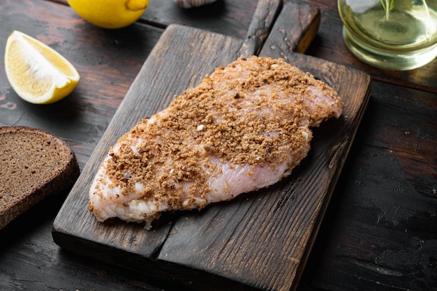 Crispy garlicky chicken raw ingredient, on wooden table