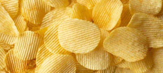 Crispy golden potato chips snack texture background