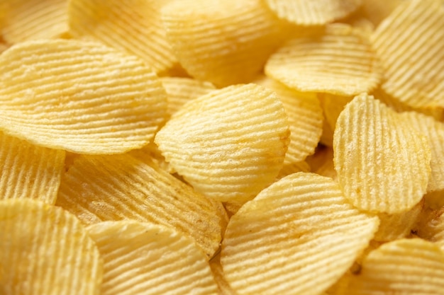 Foto fondo dorato croccante di struttura dello spuntino delle patatine fritte