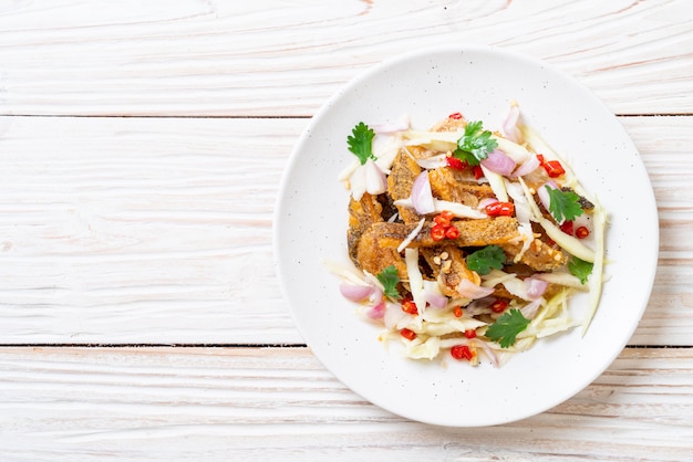 Crispy gourami fish with spicy salad