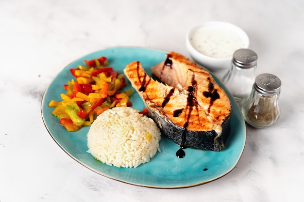 Crispy grilled salmon steak with steamed paprika and rice