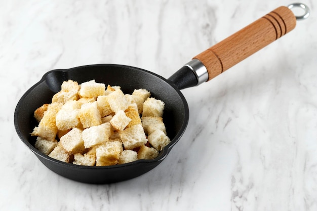 Crispy Homemade Croutons for SOup Side Dish Served on Cast Iron Pan