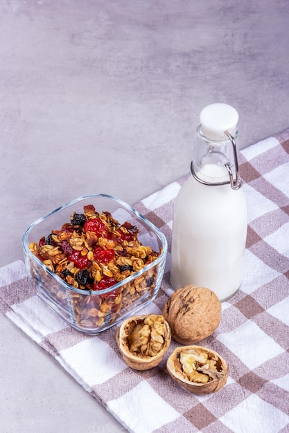 Crispy muesli with walnuts and a bottle of milk