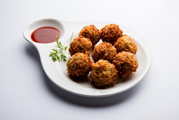 Crispy Noodles Pakora or pakoda is a popular indo-chinese street food served with ketchup