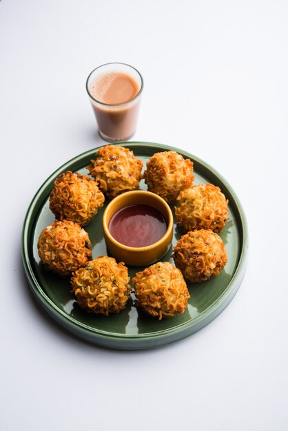 Crispy Noodles Pakora or pakoda is a popular indo-chinese street food served with ketchup