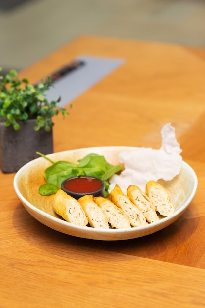 Crispy pancakes stuffed with squid cheese and herbs with sauce in a Asian restaurant