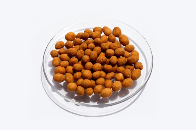 Crispy peanut snack balls on white background.