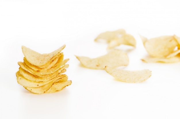 Crispy potato chips isolated on white background