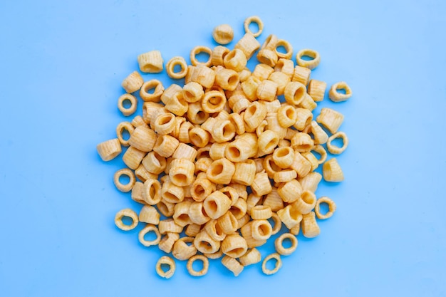 Crispy potato rings on blue background