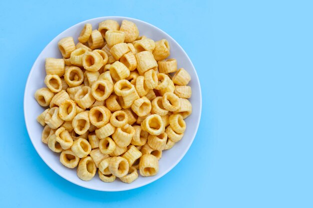 Crispy potato rings on blue background